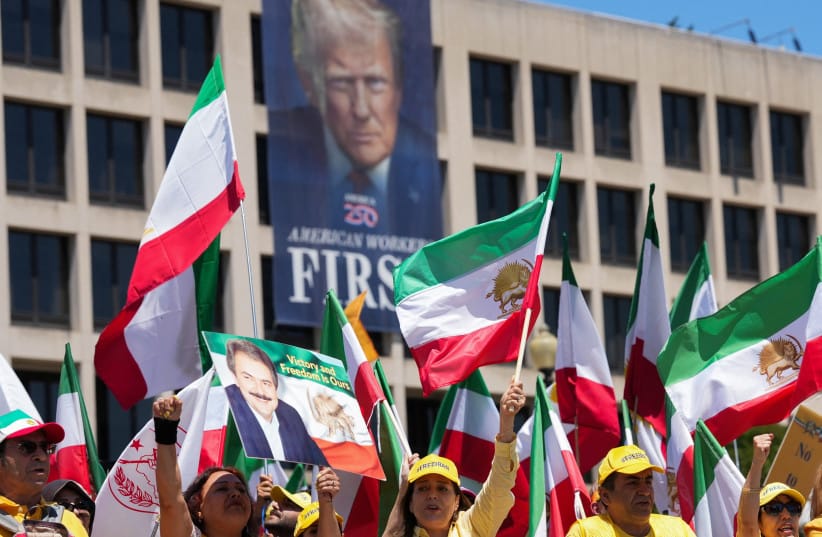 Iranian Americans and supporters of the National Council of Resistance of Iran take part in a march passing in front of the U.S Department of Labor building with a banner with the image of U.S. President Donald Trump, in Washington, DC, US, May 16, 2026.
