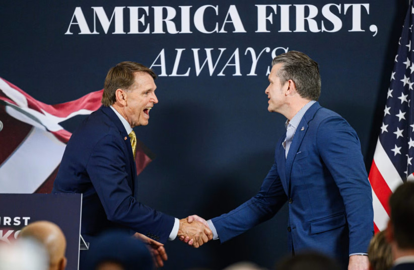 Ed Gallrein, Republican congressional candidate for Kentucky, greets U.S. Secretary of Defense Pete Hegseth on stage during an event one day before Gallrein's primary against Rep. Thomas Massie, May 18, 2026 in Hebron, Kentucky.