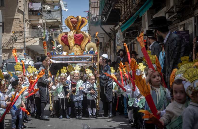 Children from the Toldot Aharon Talmud Torah march through the Mea Shearim neighborhood in Jerusalem ahead of the Shavuot holiday. May 19, 2026.