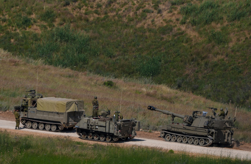 Israeli self-propelled artillery vehicles travel in a convoy toward southern Lebanon near the Israeli-Lebanese border, May 27, 2026.
