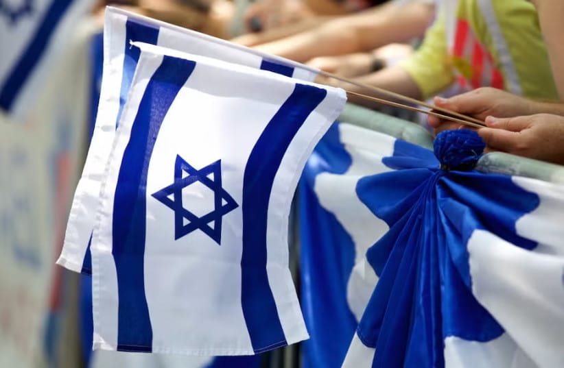 Marchers carry Israeli flags during the Celebrate Israel Parade, June 2, 2019.