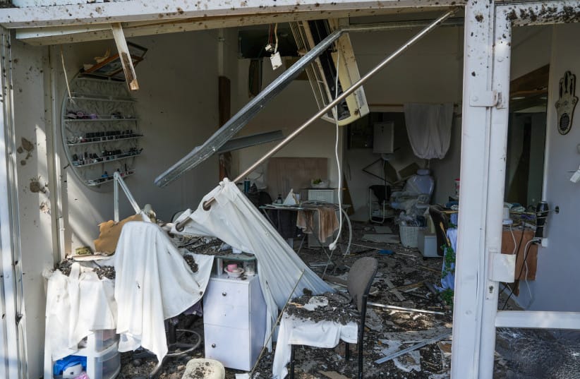 Israeli security forces and civilians at the scene where a missile fired from Lebanon toward Israel overnight caused damage in the northern Israeli city of Kiryat Shmona, May 30, 2026.