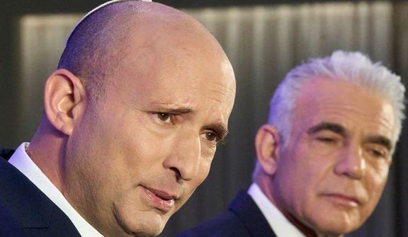 Former Israeli prime ministers Naftali Bennett, left, and Yair Lapid hold a joint press conference announcing that their parties will run together in the upcoming elections, on Sunday.