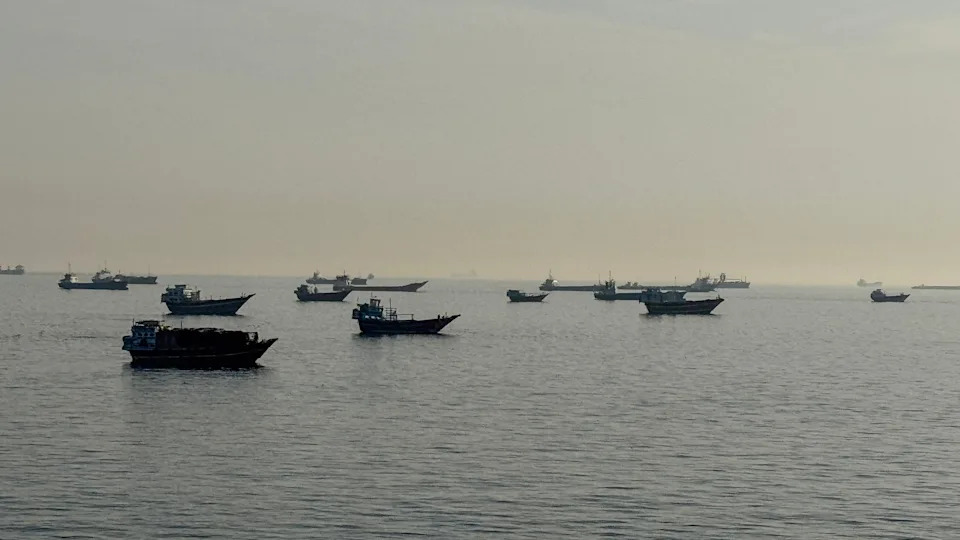 AFP via Getty Images - PHOTO: Vessels are seen anchored in the Strait of Hormuz, off the port city of Khasab on Oman's northern Musandam Peninsula on May 17, 2026.