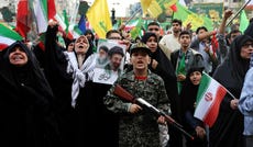 TOPSHOT - A young enthusiast dressed in military attire holds a mock rifle during a rally to show solidarity and support to the new Iranian supreme leader Ayatollah Mojataba Khamenei in Tehran, on April 29, 2026. US President Donald Trump on April 29 warned Iran to "better get smart soon" as efforts by Washington and Tehran to end hostilities appeared at a standstill. (Photo by AFP) /