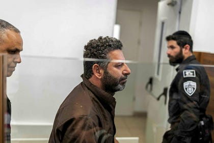 Security personnel escort Spanish activist Saif Abu Keshek to a court in Ashkelon on Sunday. Credit: Ilia Yefimovich/AFP Security personnel escort Spanish activist Saif Abu Keshek to a court in Ashkelon on Sunday.