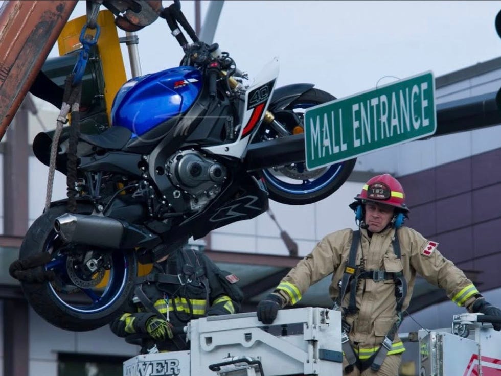 firefighters responding to a motorcycle incident near a mall entrance