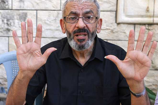 PALESTINIAN-ISRAEL-CONFLICT-MEDIA-PRISONER Palestinian journalist Ali al-Samoudi speaks to the press at his home in the northern city of Jenin, in the Israeli-occupied Palestinian West Bank on May 1, 2026. Sixty-year-old Al-Samoudi was released following one-year in detention in the Israeli Naqab Prison, located in southern Israel. He was released and checked at the Jenin Hospital where he said, "I was 120 kilogrammes; my weight now is barely 60 kilogrammes". Israel has jailed an increasing number of journalists since 2023, the year of Hamas's unprecedented October 7 attack on Israel, which responded with a devastating war in the Gaza Strip. (Photo by JAAFAR ASHTIYEH / AFP via Getty Images)