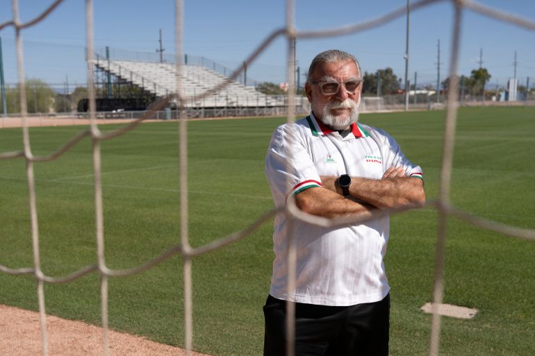 Amir Pajouyan, a member of the Iranian diaspora in Tucson, poses wearing an Iran jersey at the Kino Sports Complex, where Iran's national football team Team Melli will train during the 2026 FIFA World Cup, in Tucson, Arizona, on May 6, 2026. In the Strait of Hormuz, US warships menace Iran's oil tankers. In Washington, President Donald Trump threatens nothing less than "complete victory" will suffice. But in Tucson, they're getting ready to welcome the Iranian football team as if nothing were amiss. The city, an oasis of manicured lawns in the Arizona desert, is set to be the base camp for "Team Melli" when the world's biggest sporting spectacle opens in the US, Mexico and Canada next month. (Photo by Rebecca NOBLE / AFP)