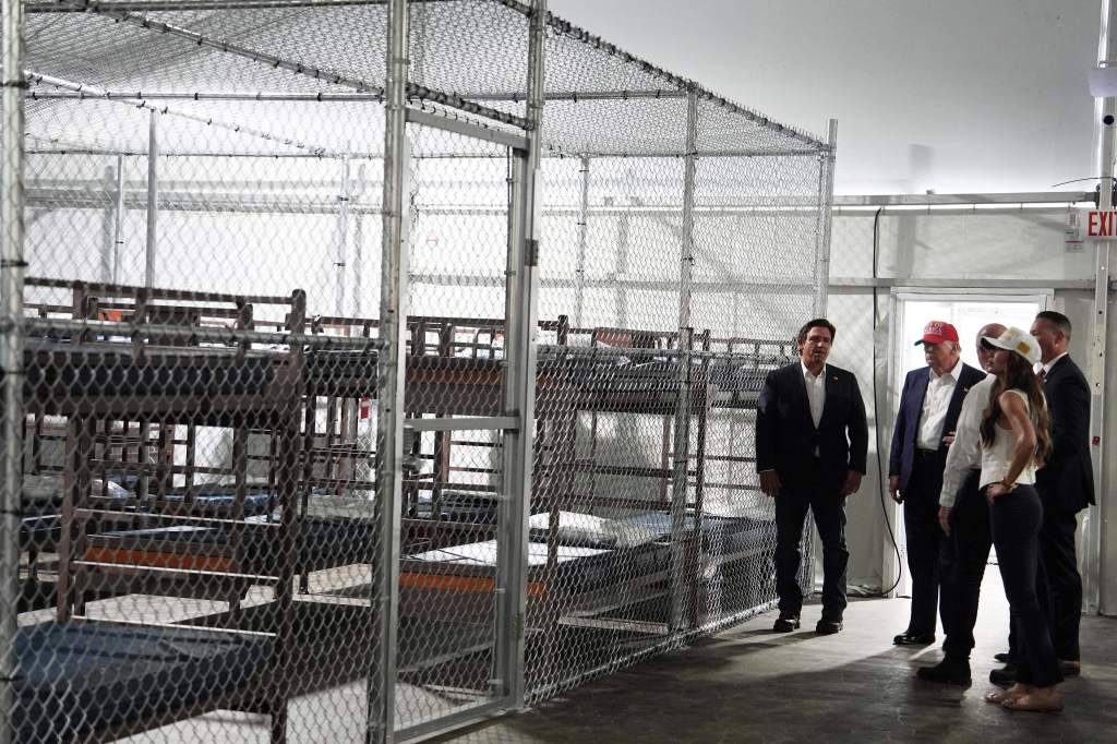 President Donald Trump, Gov. Ron DeSantis, R-Fla., and Homeland Security Secretary Kristi Noem, and others, tour "Alligator Alcatraz," a new migrant detention facility at Dade-Collier Training and Transition facility, Tuesday, July 1, 2025, in Ochopee, Fla. 