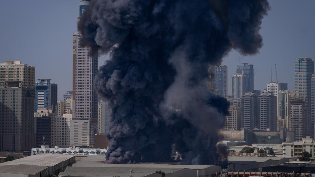 A black plume of smoke rises from a warehouse at the industrial area of Sharjah City in the United Arab Emirates on Sunday, March 1, 2026