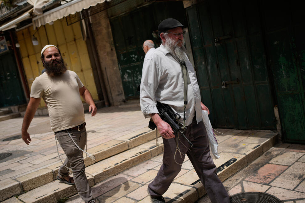 An armed Israeli walks in Jerusalem's Old City, ahead of a march marking Jerusalem Day, an Israeli holiday celebrating the capture of east Jerusalem in the 1967 Mideast war, on May 14, 2026