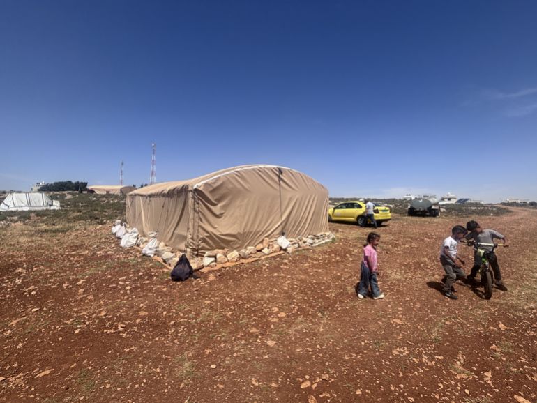 Children next to a tent