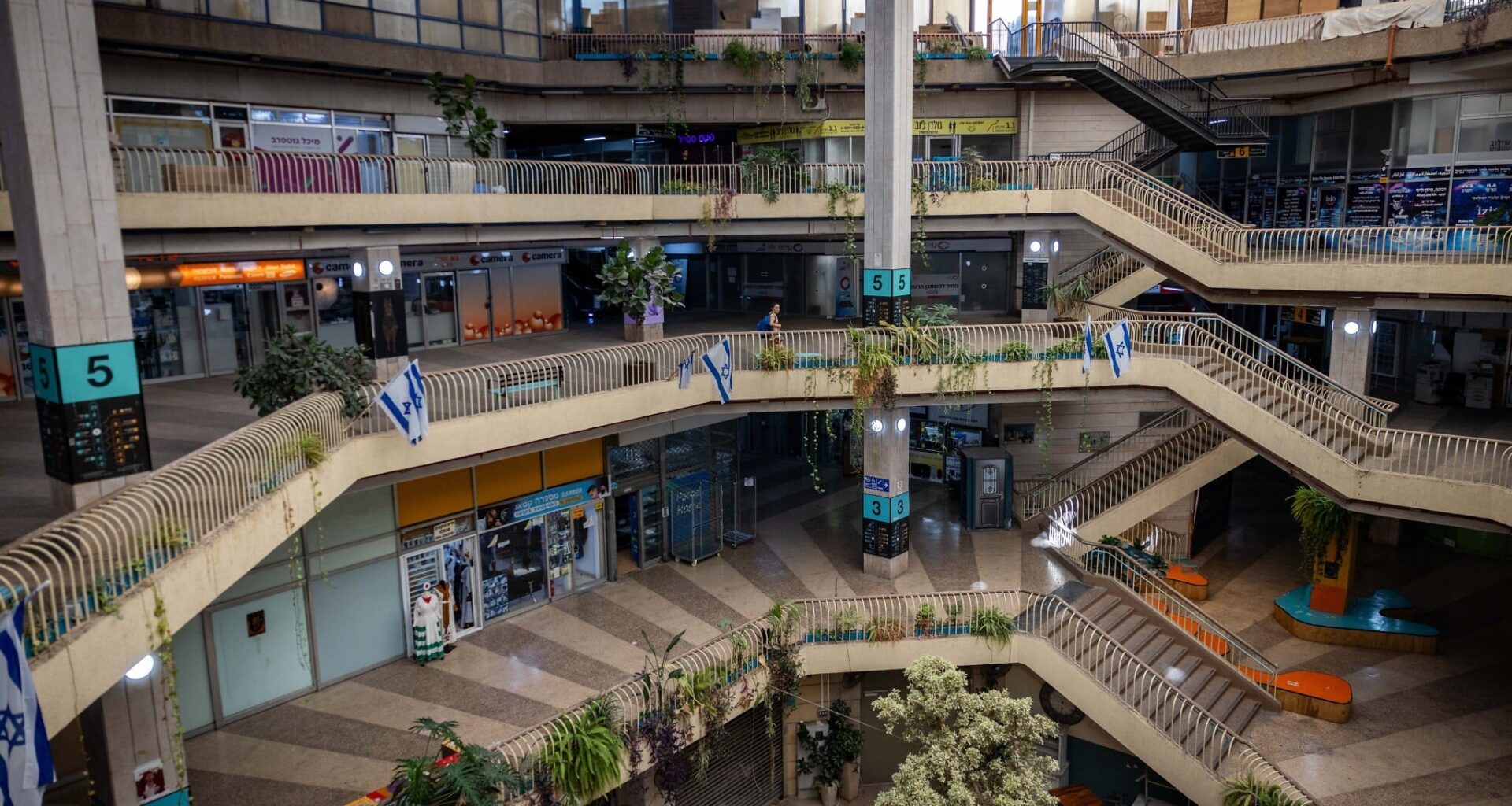 People walking inside the Clal building in central Jerusalem, on July 8, 2025 (Yonatan Sindel/Flash90)