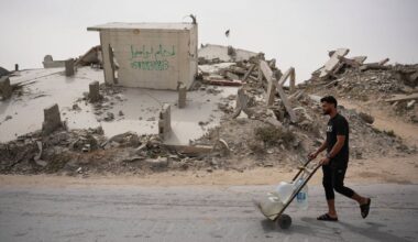 A Palestinian man carries water containers in Gaza City, Tuesday, May 12, 2026. (AP Photo/Abdel Kareem Hana)