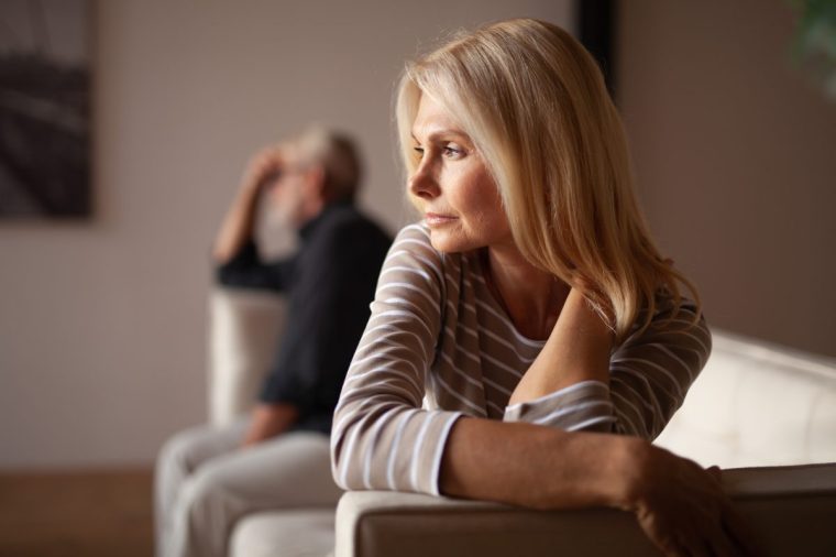 The older couple has a conflict. Upset mature woman, quarrel with her husband. Relationship crisis - stock photo