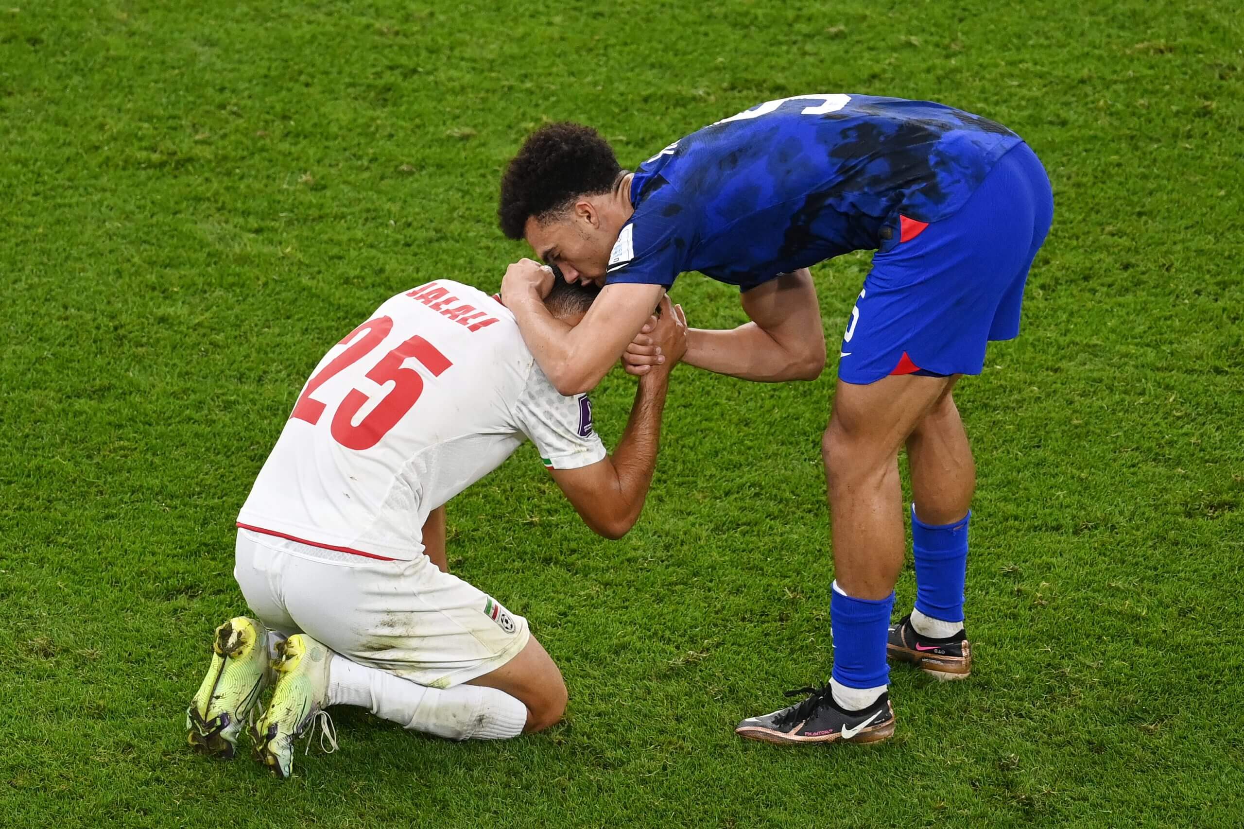 Antonee Robinson consoles Abolfazl Jalali after the USA beats Iran at the 2022 World Cup