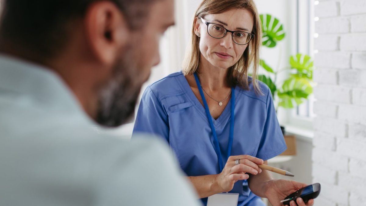 Diabetologist doctor waiting for result from glucose testing in diabetes clinic. - stock photo