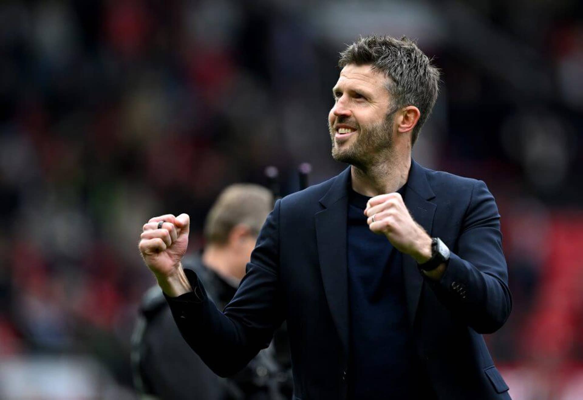 Michael Carrick celebrates with his fists raised after a Manchester United victory.