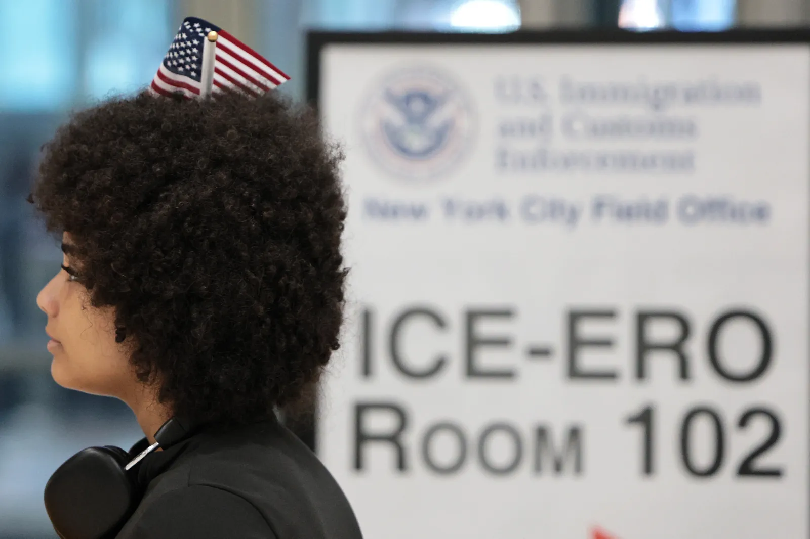 A person wears an American flag on their head after attending a Naturalization Ceremony at 26 Federal Plaza on May 08, 2026 in New York City.