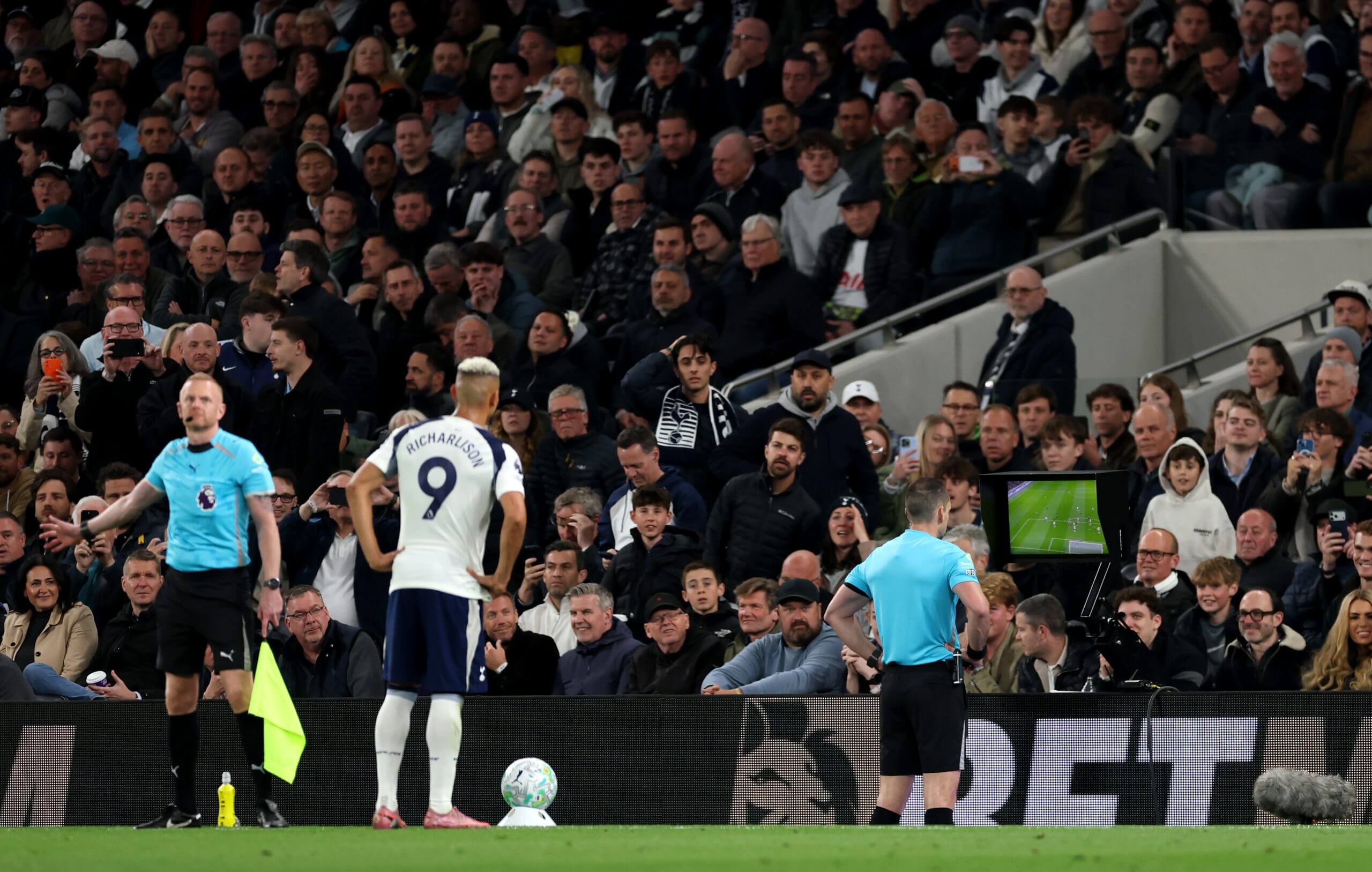 Jarred Gillett checks the VAR screen at Tottenham Hotspur