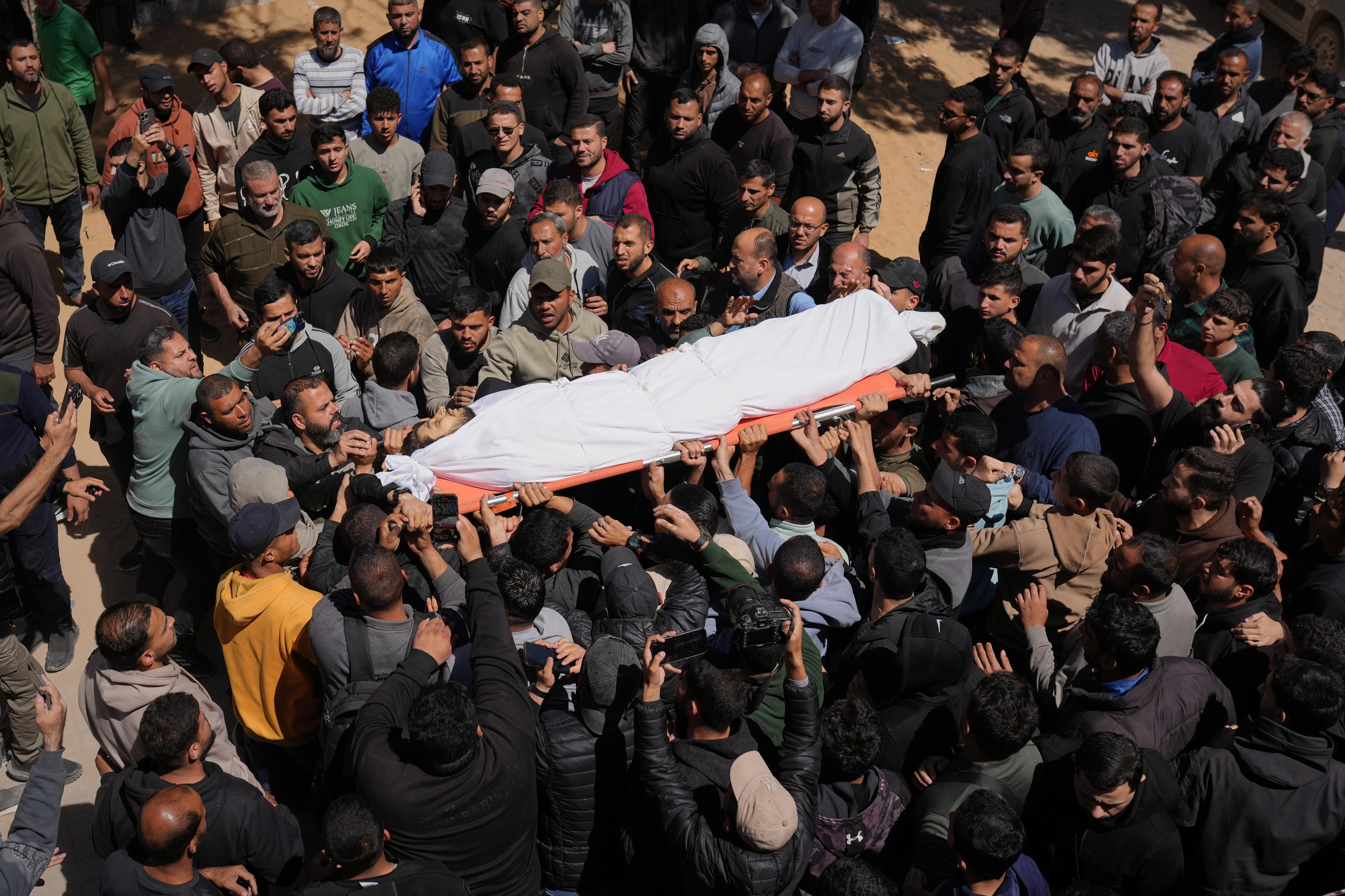 Mourners carry the body of Azzam al-Hayya, son of Hamas leader Khalil al-Hayya.