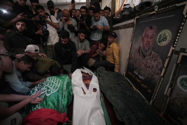Palestinians mourn over the bodies of Izz al-Din al-Haddad, his daughter and his wife.
