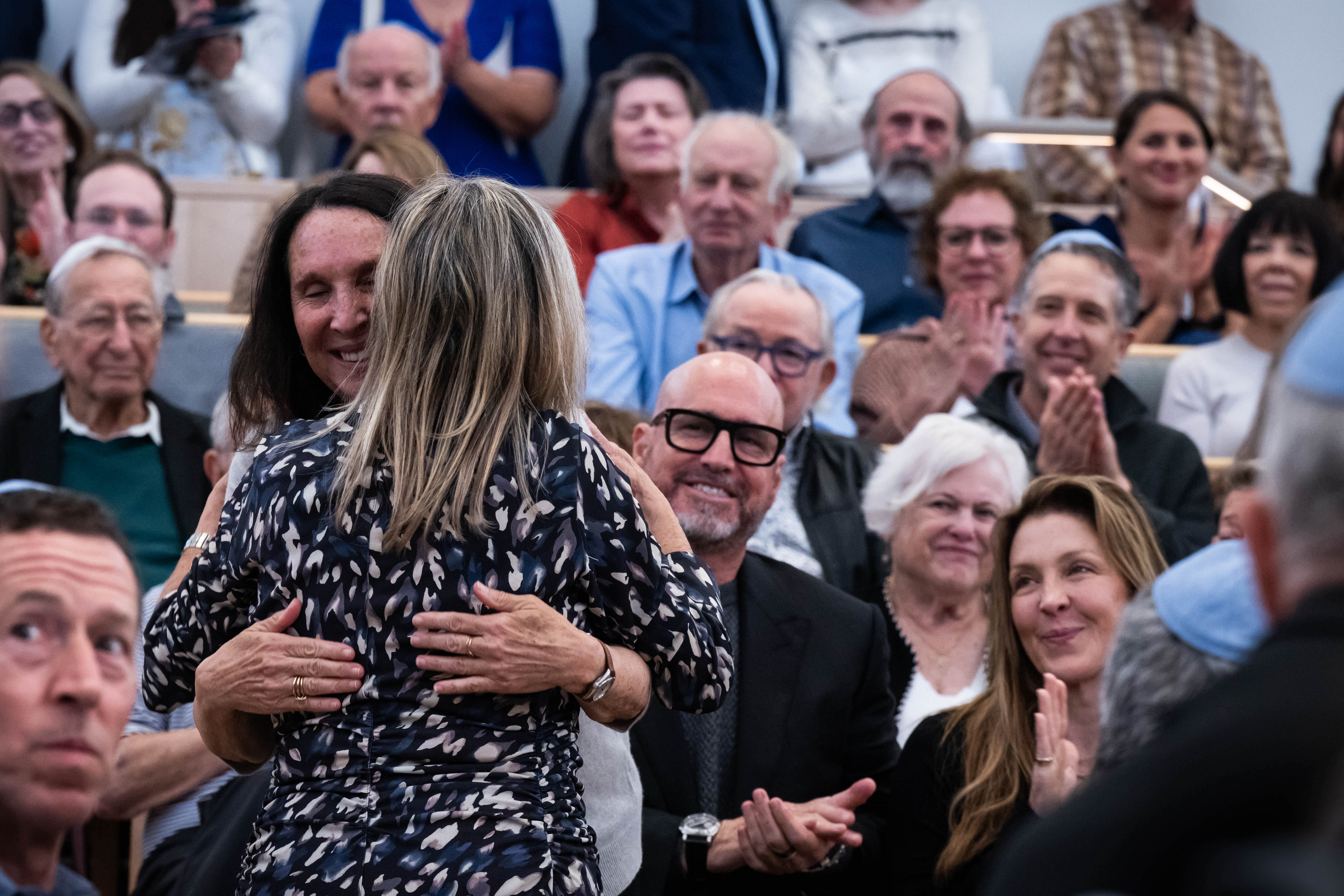 Donor families hug at Kehillat Israel in their new sanctuary...