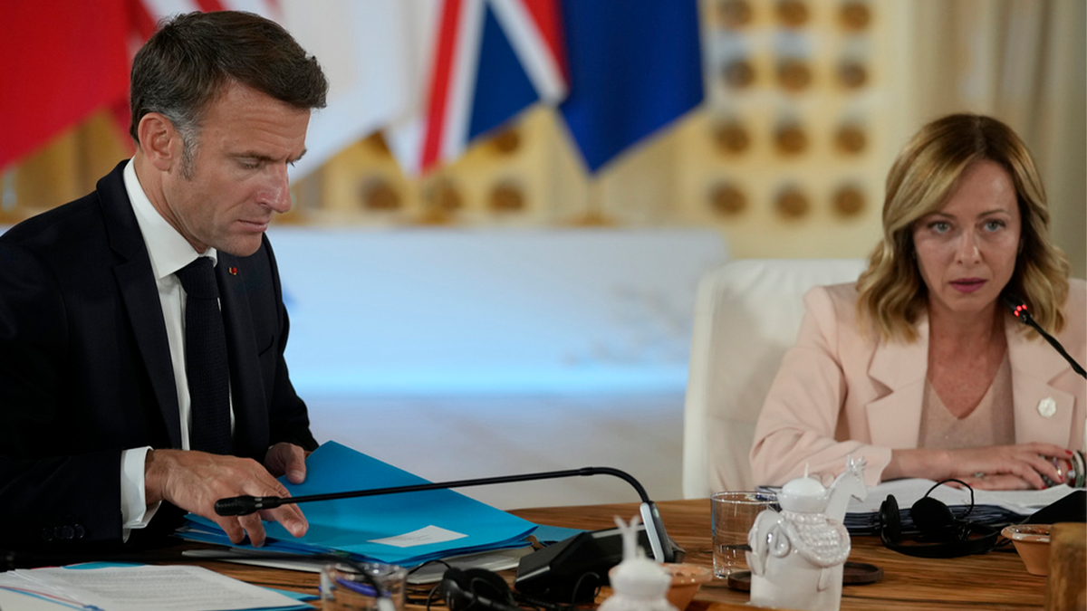 French President Emmanuel Macron listening to Italian Prime Minister Giorgia Meloni during a G7 summit session