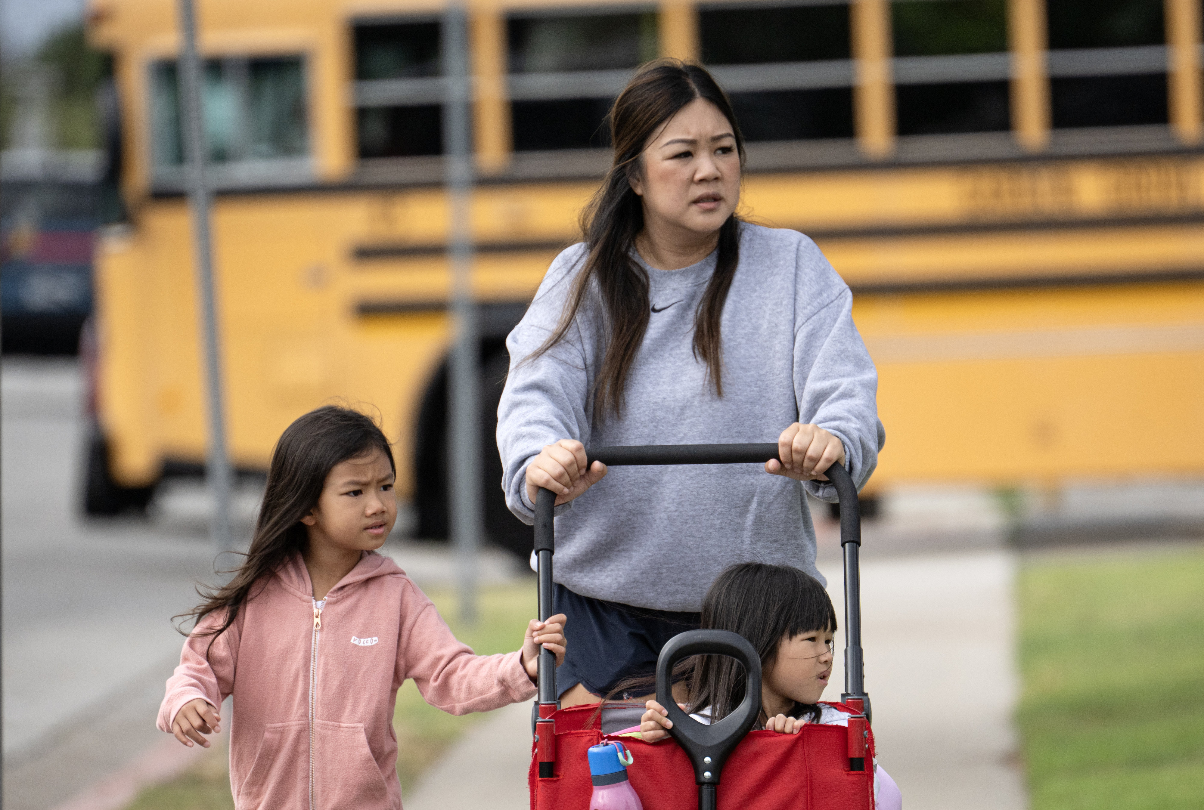 Helen Damâwalks he 6-year-old daughter, Taylor, left,back to school in...