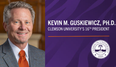 smiling man wearing coat and tie, graphic naming Guskiewicz named 16th president of Clemson University