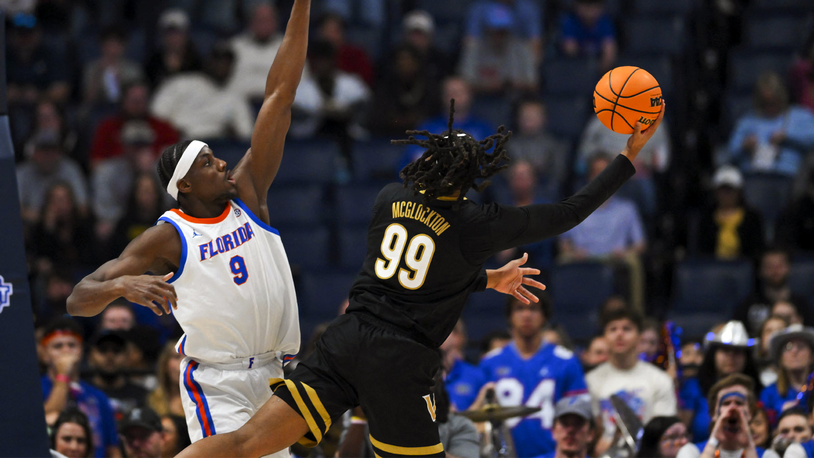 Vanderbilt Commodores forward Devin McGlockton (99) shoots over Florida Gators center Rueben Chinyelu (9) during the first half at Bridgestone Arena. 