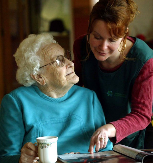 A elderly woman and her carer looks at a magazine in a residential care home in Bath, on March 21, 2006 in Somerset, England. As people live longer and longer lives, social health care provision for elderly people and those with health complications in older age, how to pay for it has remained a major issue for successive governments.