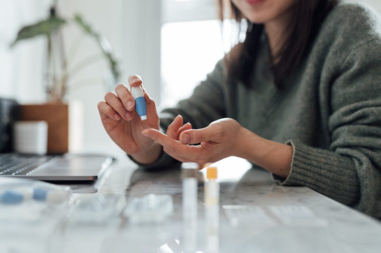 A young woman does a fingerprick blood test
