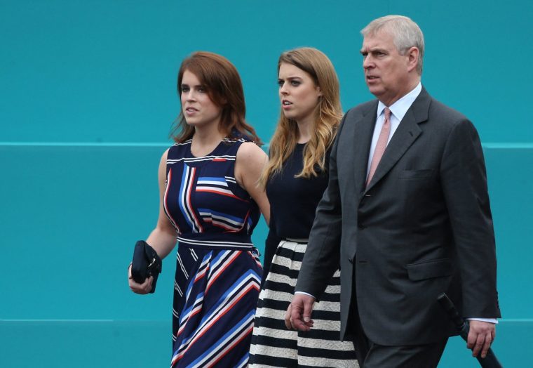 (L-R) Britain's Princess Eugenie of York, Britain's Princess Beatrice of York and Britain's Prince Andrew, Duke of York leave Buckingham Palace to meet guests at the Patron's Lunch, a special street party outside Buckingham Palace in London on June 12, 2016, as part of the three day celebrations for Queen Elizabeth II's official 90th birthday. Up to 10,000 people are expected to attend the Patron's Lunch along with the monarch, her husband Prince Philip, Prince William and Prince Harry. (Photo by JUSTIN TALLIS / AFP) (Photo by JUSTIN TALLIS/AFP via Getty Images)