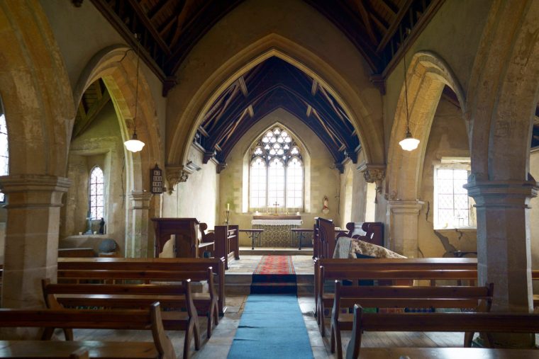 Richard Loynes, with the leaning church of Dry Doddington, Nottinghamshire, also known as St James Church. April 14, 2026. // England's wonkiest church which has a spire which leans more than the Leaning Tower of Pisa is in vital need of ??100,000 repairs to save its future - but have refused to correct the angle of its famous tower. The spire of St James' Church in the countryside village of Dry Doddington, Lincs., tilts at 5.1 degrees compared to the 3.99 degrees of its Italian counterpart over 1,000 miles away. Villagers consider the Grade II-listed building "Britain's answer to The Leaning Tower of Pisa" but there are now concerns for its future as it is need of essential repairs. Tourists often travel to snap photos next to the historic tilting place of worship, which has now launched a fundraiser to raise another ??100,000 11 years after it underwent ??100,000 of renovation work to save its tower. The 12th century church was built originally as a ???Chapel of Ease??? for older residents to attend church rather than walking to a neighbouring village. The tower, dating from the 14th century, is believed to have first shifted in the late 19th century and was underpinned in 1918 to prevent it from tilting any further. Church warden Richard Loynes said: "The church is very much part of the village and we're proud of its uniqueness.??? Photo released 15/04/2026