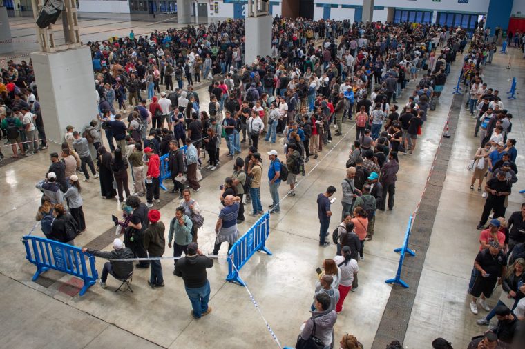 Migrants queue at a public service office to obtain paperwork needed to apply for Spain's immigration amnesty, which could allow hundreds of thousands of people to obtain legal status, in L'Hospitalet de Llobregat near Barcelona, Spain, Tuesday, April 21, 2026. (AP Photo/Emilio Morenatti)