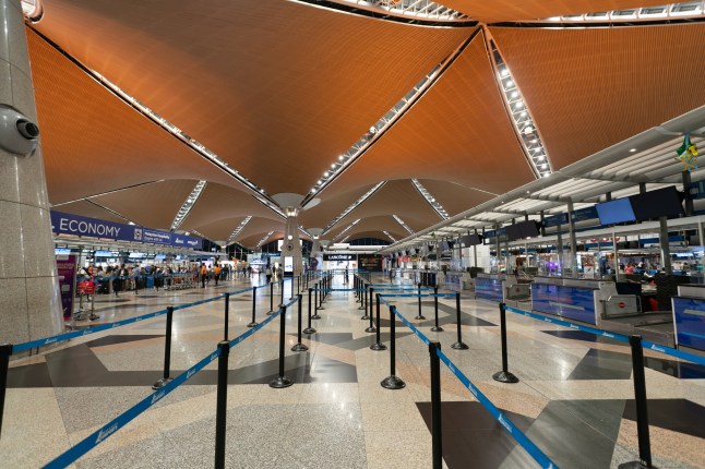 Sepang, Malaysia - May 19, 2023: Check-in counters at the departure level of Kuala Lumpur International Airport.