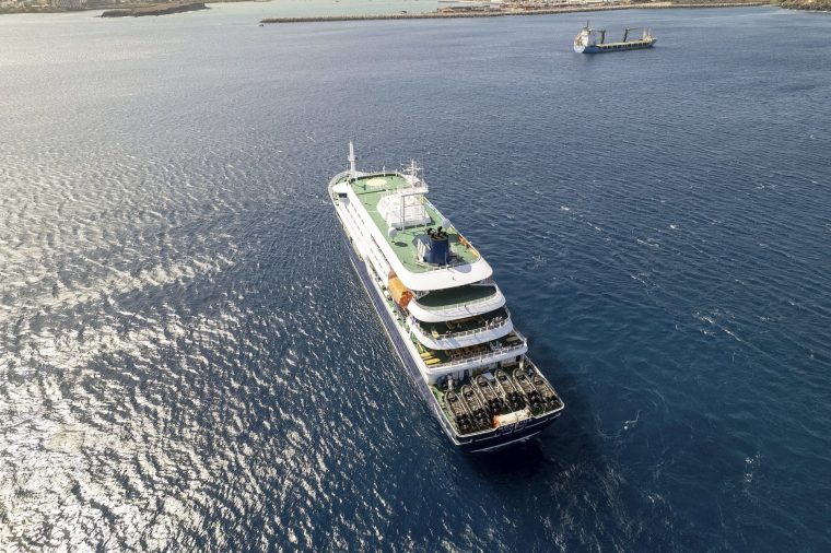 TOPSHOT - This aerial picture shows a general view of the cruise ship MV Hondius stationary off the port of Praia, the capital of Cape Verde, on May 3, 2026. An outbreak of "severe acute respiratory illness" on board a cruise ship in the Atlantic has left two people dead and a third in intensive care in Johannesburg, South Africa's health ministry told AFP on May 3, 2026. The outbreak occurred on the MV Hondius, travelling from Ushuaia in Argentina to Cape Verde. The patient being treated in Johannesburg tested positive for a hantavirus, a family of viruses that can cause hemorrhagic fever, South African spokesperson Foster Mohale said. (Photo by AFP via Getty Images)