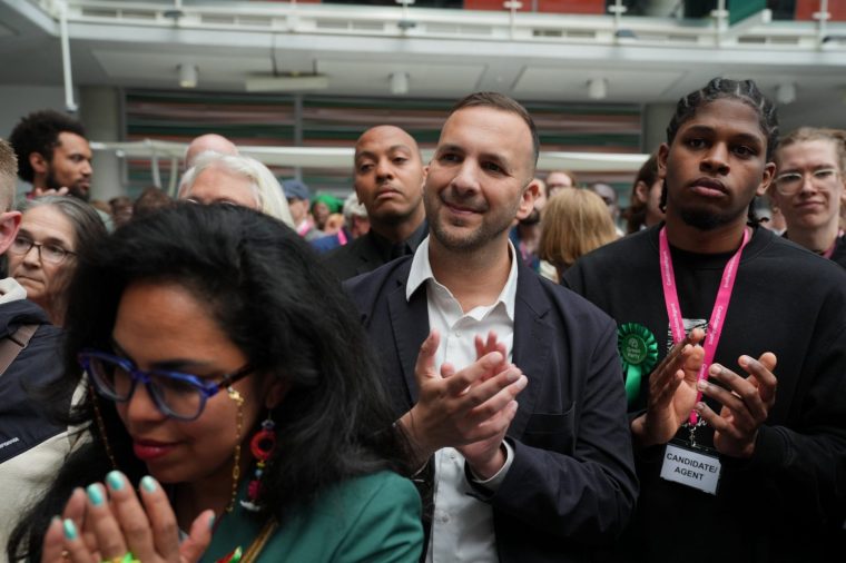 Green Party leader Zack Polanski applauds after Zoe Garbett was declared the winner for the 2026 London Borough of Hackney mayoral election at Hackney Service Centre, east London. Picture date: Friday May 8, 2026. PA Photo. Photo credit should read: Yui Mok/PA Wire