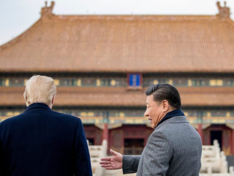 FILE - President Donald Trump and Chinese President Xi Jinping speak together as they tour the Forbidden City, Nov. 8, 2017, in Beijing, China. (AP Photo/Andrew Harnik, File)