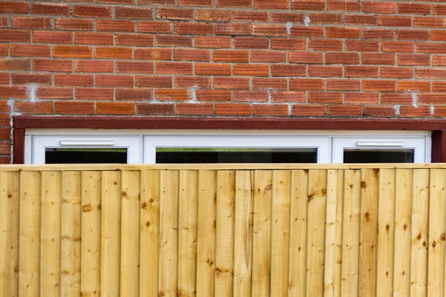 Neighbours have been left baffled after a council installed a huge garden fence across a living room window. Large wooden panels have completely obscured the view from inside after being placed just centimetres away from the house. The home in Bristol is currently unoccupied but council staff were seen carrying out work at the property this week.. Bristol. 12 May 2026. Photo released 13/05/2026