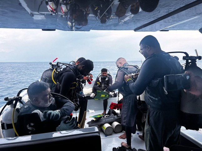 This image released by the Maldives President's Media Division, shows divers preparing to search for the four missing Italian divers near Alimathaa Island, Vaavu Atoll, Maldives, Saturday, May 15, 2026. (Maldives President's Media Division via AP)