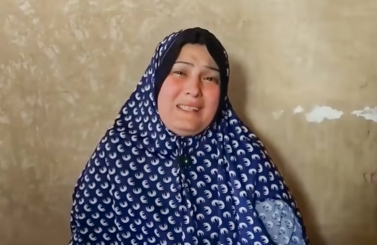 Gaza mother Maha Abu Al-Shaar holds her phone displaying a photo of her son, Eid, as she cries with joy and sadness after discovery that he is alive in an Israeli prison, 18 months after being declared a martyr and missing. [Screengrab/Al Jazeera]