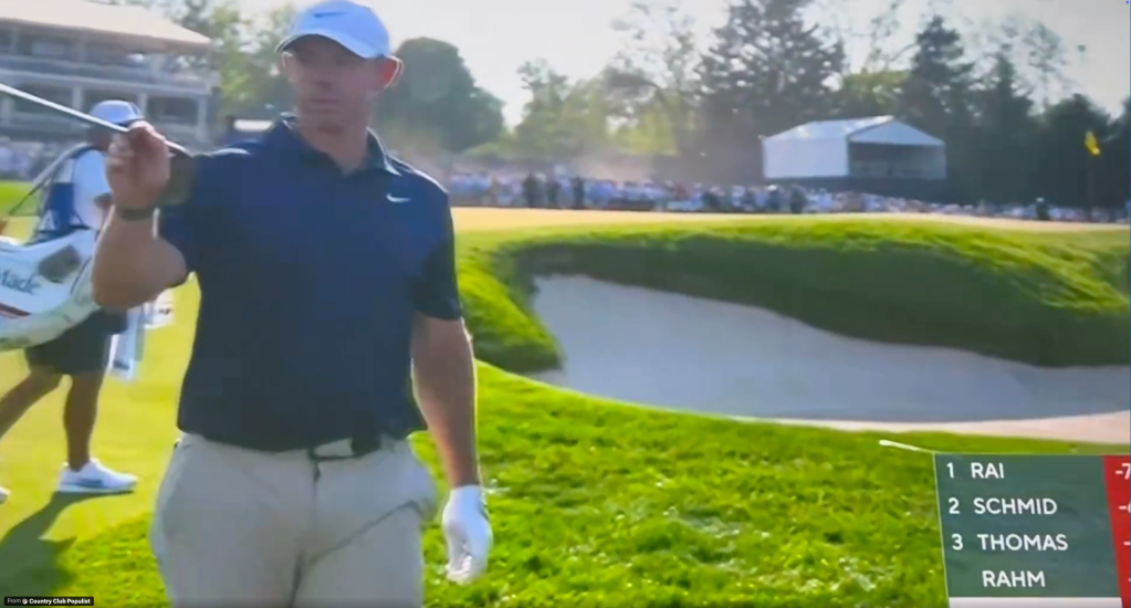 A golfer in a blue shirt and white hat holds a golf club with a golf scoreboard in the bottom right corner.