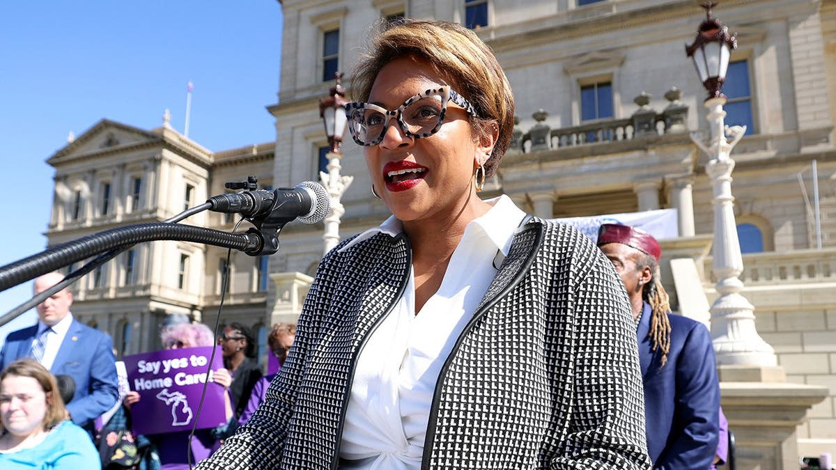 Sylvia Santana speaking at a podium during a session of the Michigan State Senate.