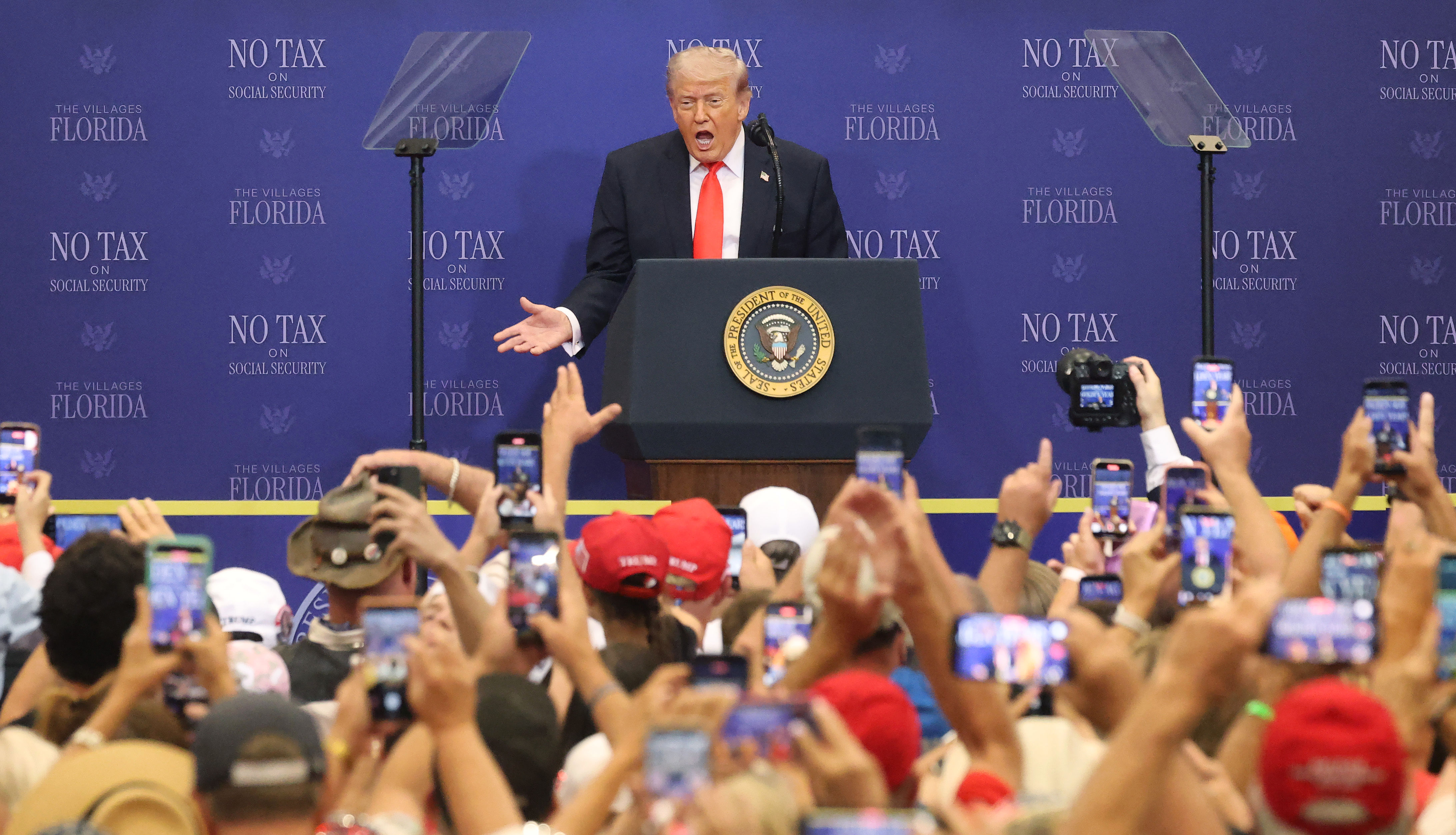 President Donald Trump responds to a cheering crowd as he...