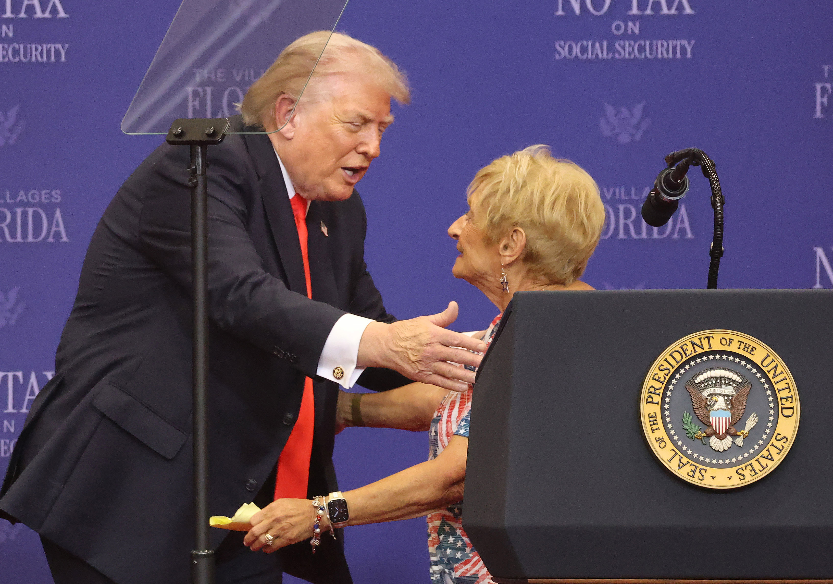 President Donald Trump thanks a Villages resident on stage for...