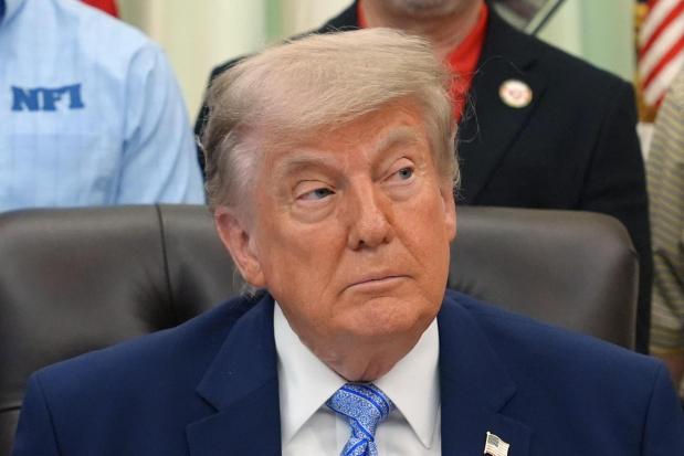 President Donald Trump attends an event about loosening a federal refrigerant rule.