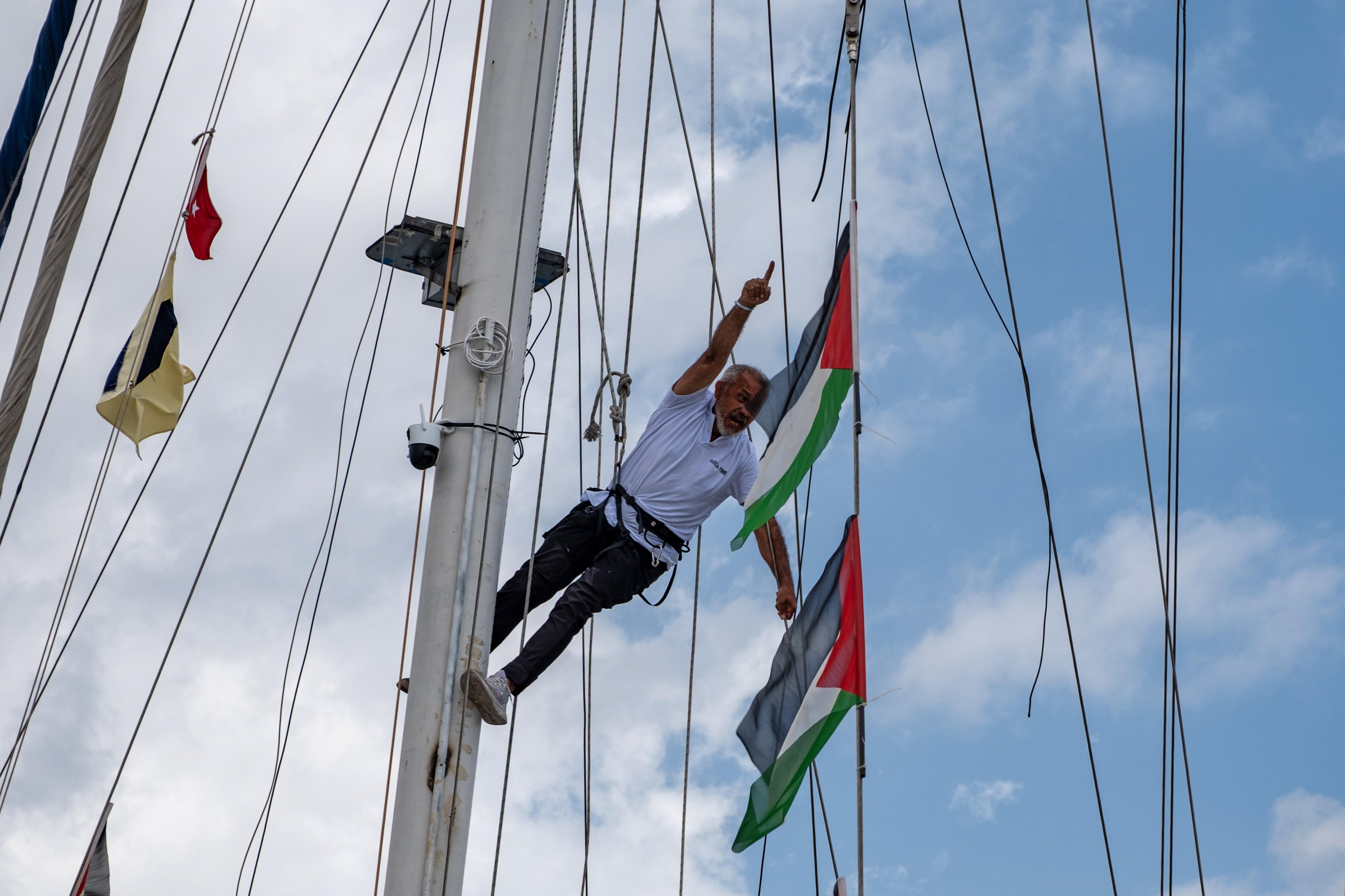 An activist rests as boats belonging to the Global Sumud Flotilla begin to depart for Gaza.